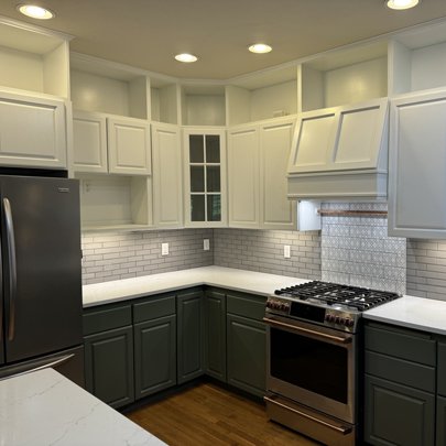 Painted kitchen cabinets with glass panel doors by Capitol Painting Company.